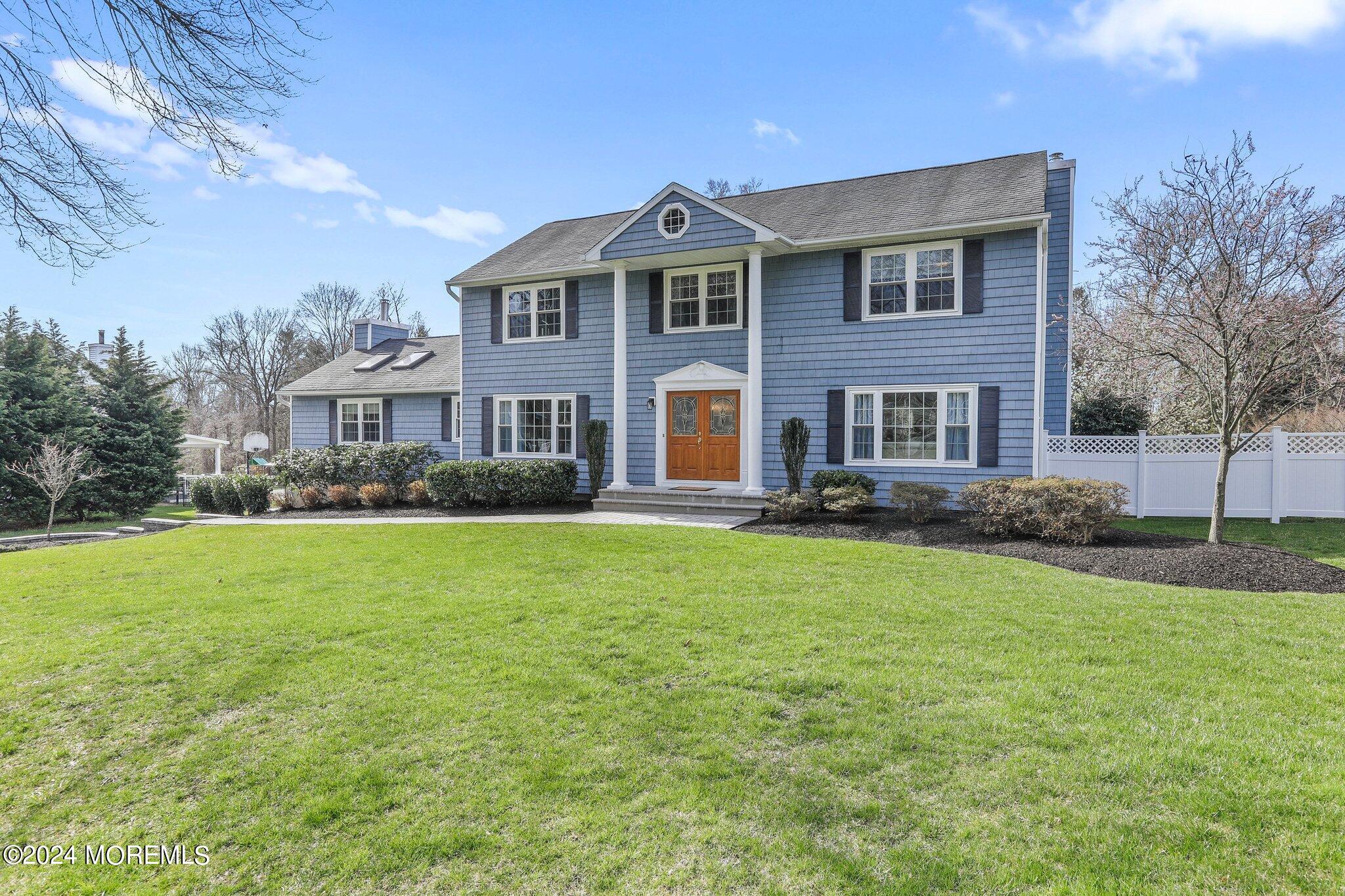 234 Yale Drive Lincroft, NJ 07738 - Photo 2 of 38 a front view of a house with a yard