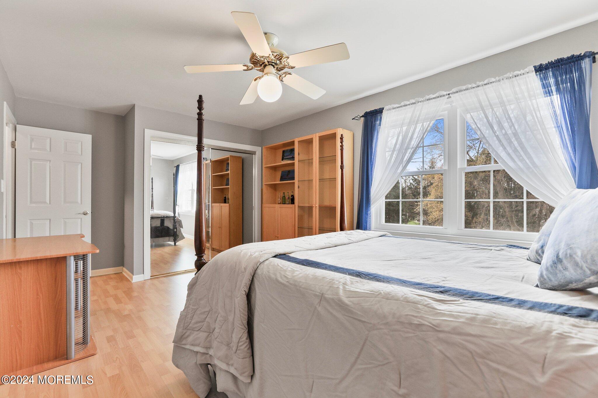 234 Yale Drive Lincroft, NJ 07738 - Photo 26 of 38 a spacious bedroom with a large bed and a large window