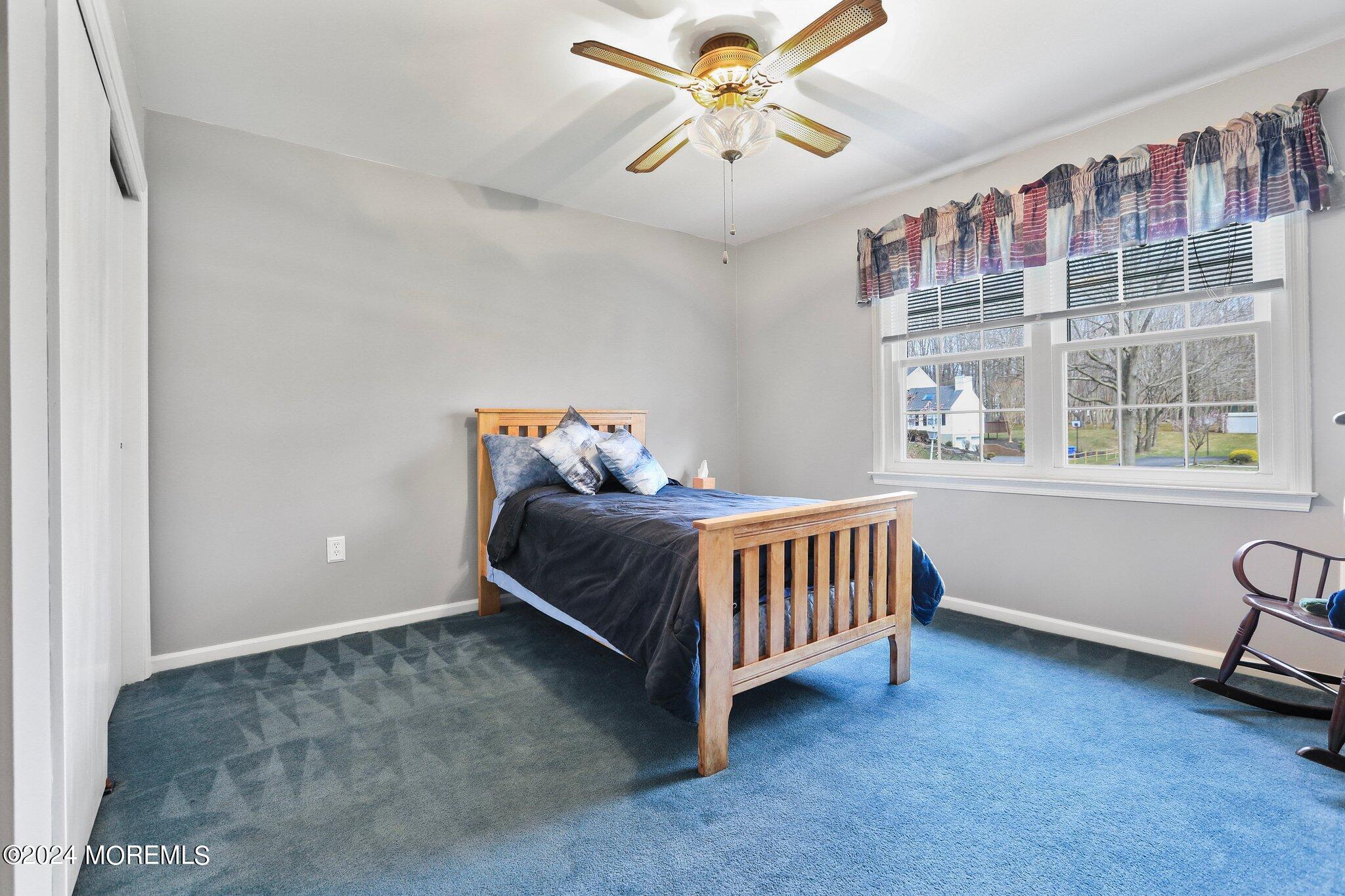 234 Yale Drive Lincroft, NJ 07738 - Photo 27 of 38 a bedroom with a bed and a chandelier