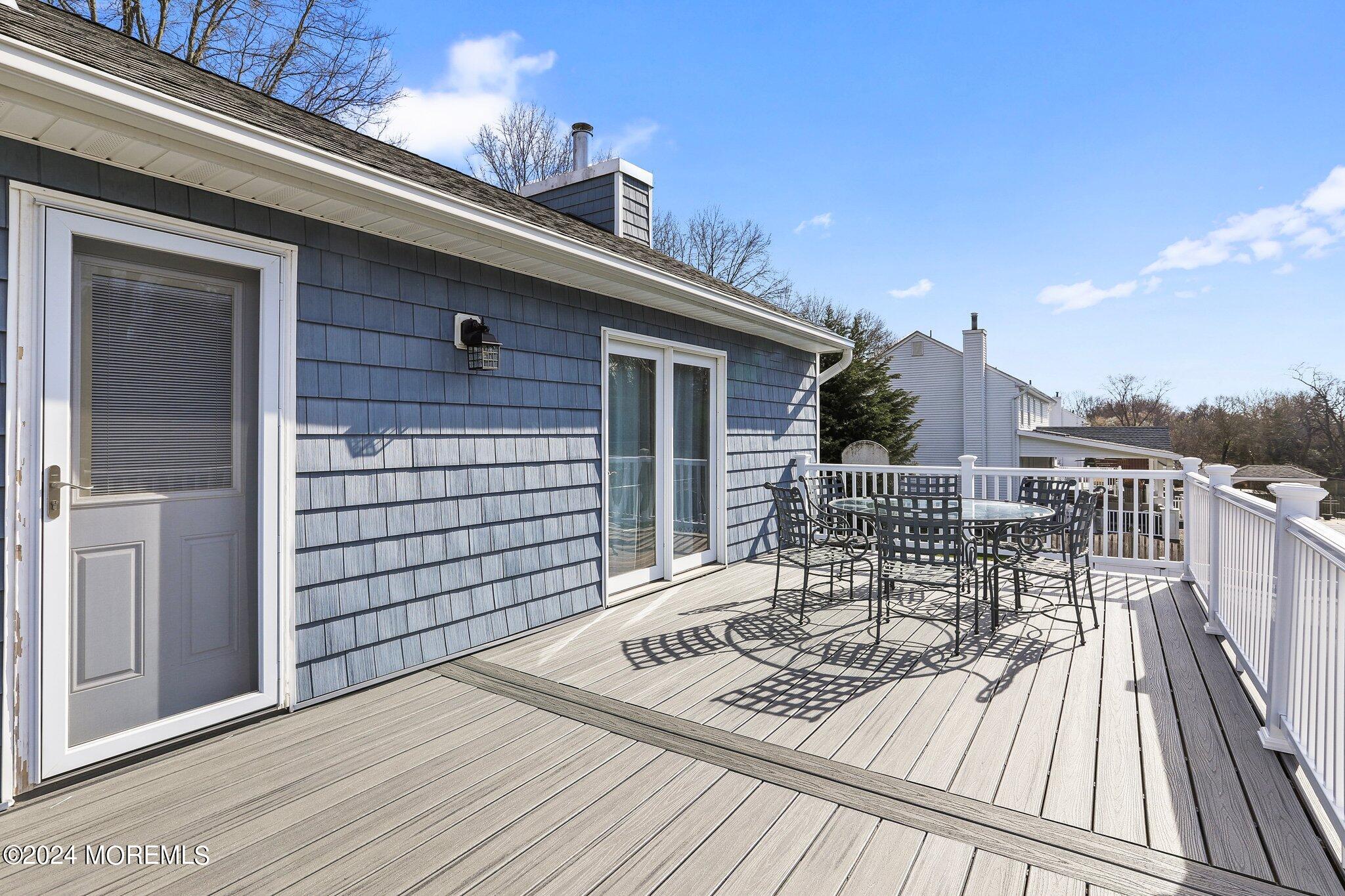 234 Yale Drive Lincroft, NJ 07738 - Photo 30 of 38 a view of a balcony with two chairs and wooden floor