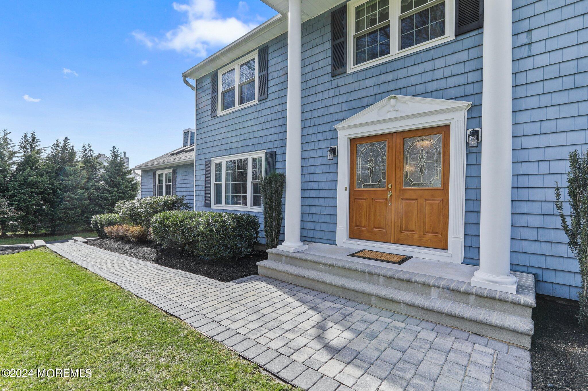 234 Yale Drive Lincroft, NJ 07738 - Photo 4 of 38 a front view of a house with a yard