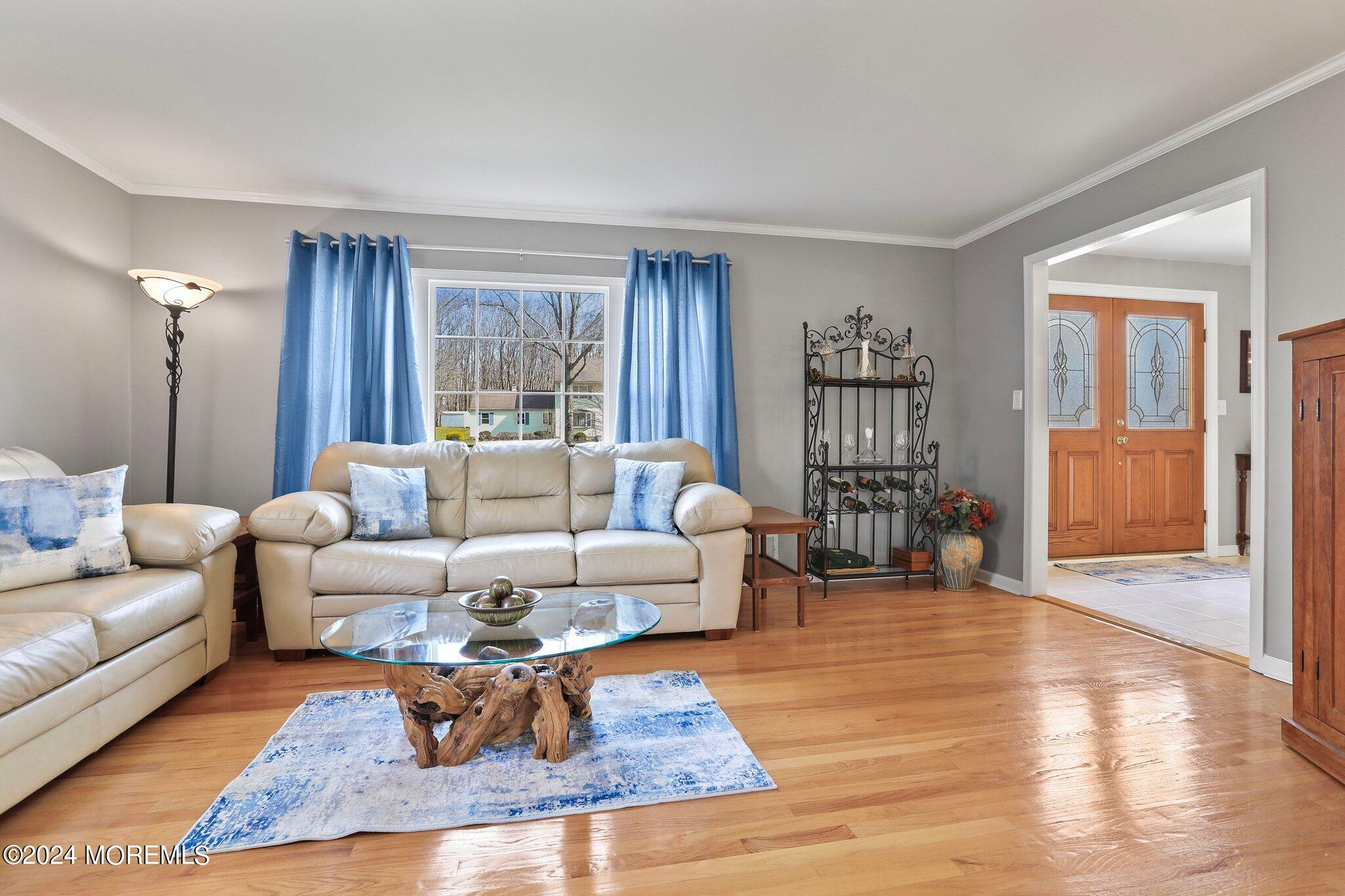 234 Yale Drive Lincroft, NJ 07738 - Photo 7 of 38 a living room with furniture a lamp wooden floor and a window