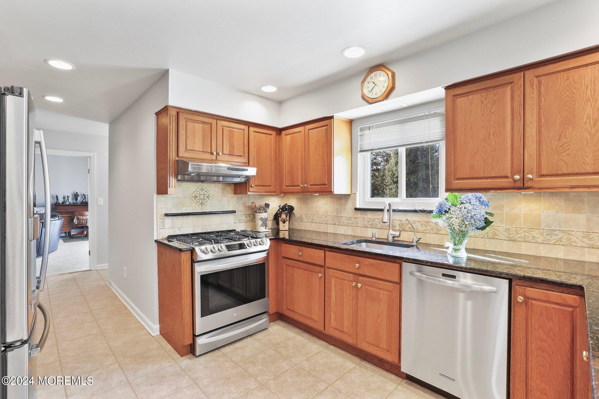 234 Yale Drive Lincroft, NJ 07738 - Photo 10 of 38 a kitchen with granite countertop stainless steel appliances a stove a sink and a microwave