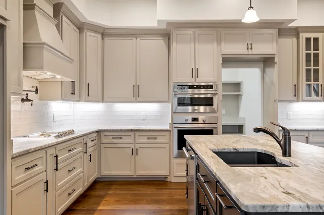 a view of an empty room with wooden floor and windows