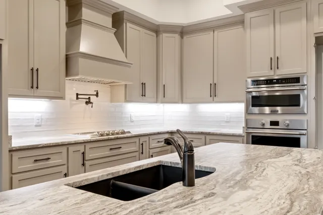 an empty room with wooden floor chandelier fan and windows