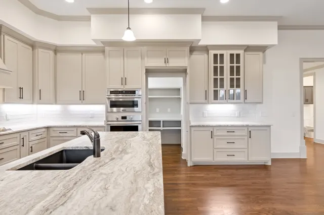 a bathroom with a sink a toilet a mirror and shower