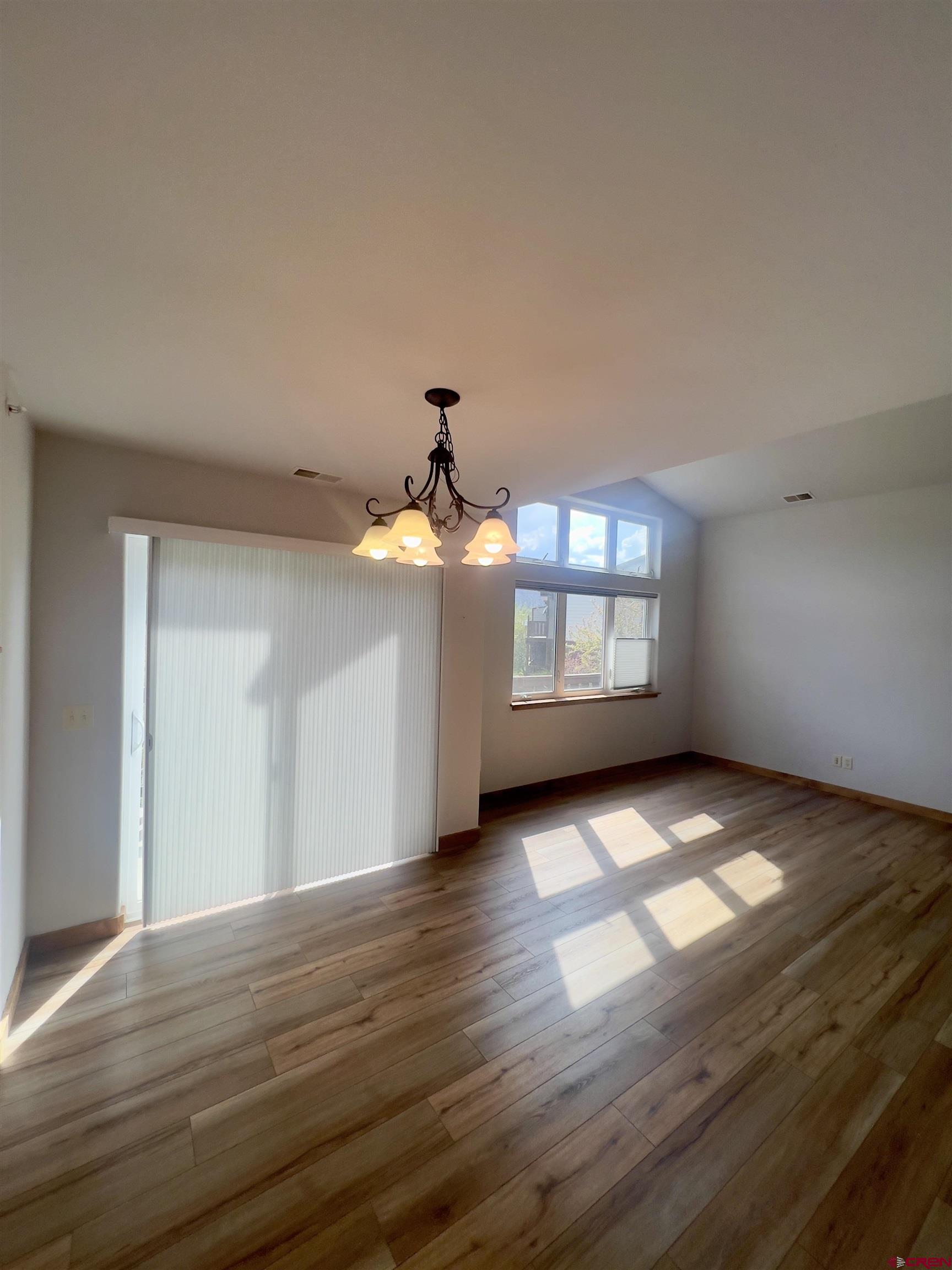 540 Redcliff Circle, Unit E 203 Ridgway, CO 81432 - Photo 12 of 36 a view of an empty room with window and wooden floor