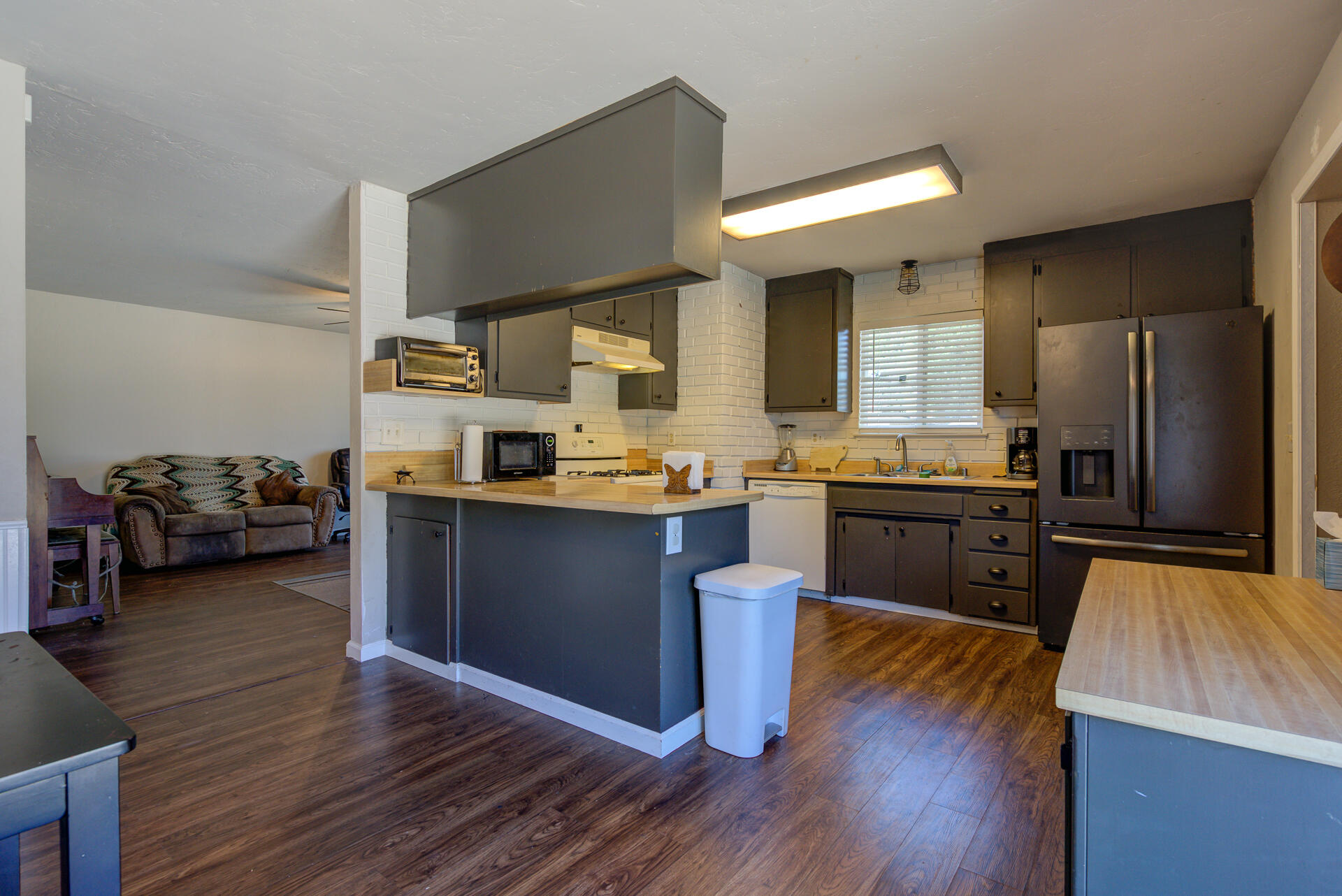 2689 Shasta View Drive Redding, CA 96002 - Photo 7 of 33 a kitchen with kitchen island granite countertop wooden floors stainless steel appliances and a sink