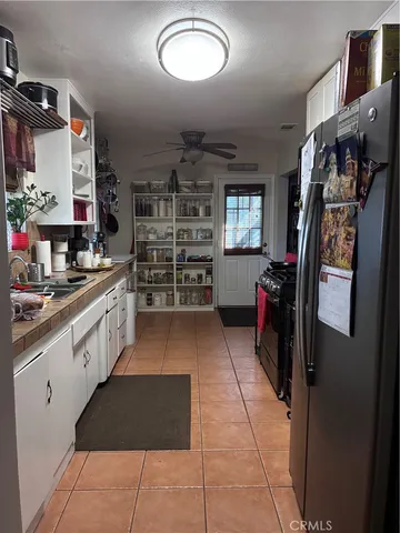 a kitchen with refrigerator and cabinets