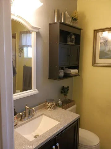 a bathroom with a sink a toilet and mirror