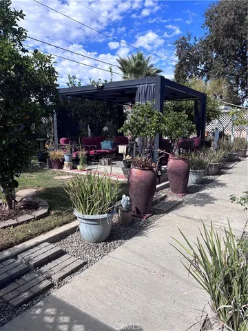a view of a backyard with sitting area and a garden
