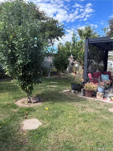 a backyard of a house with table and chairs