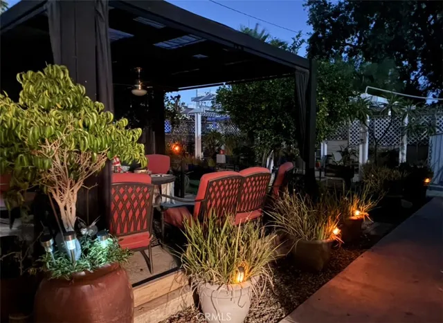 a view of a patio with table and chairs potted plants