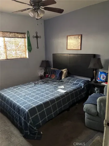 a bedroom with bed and window