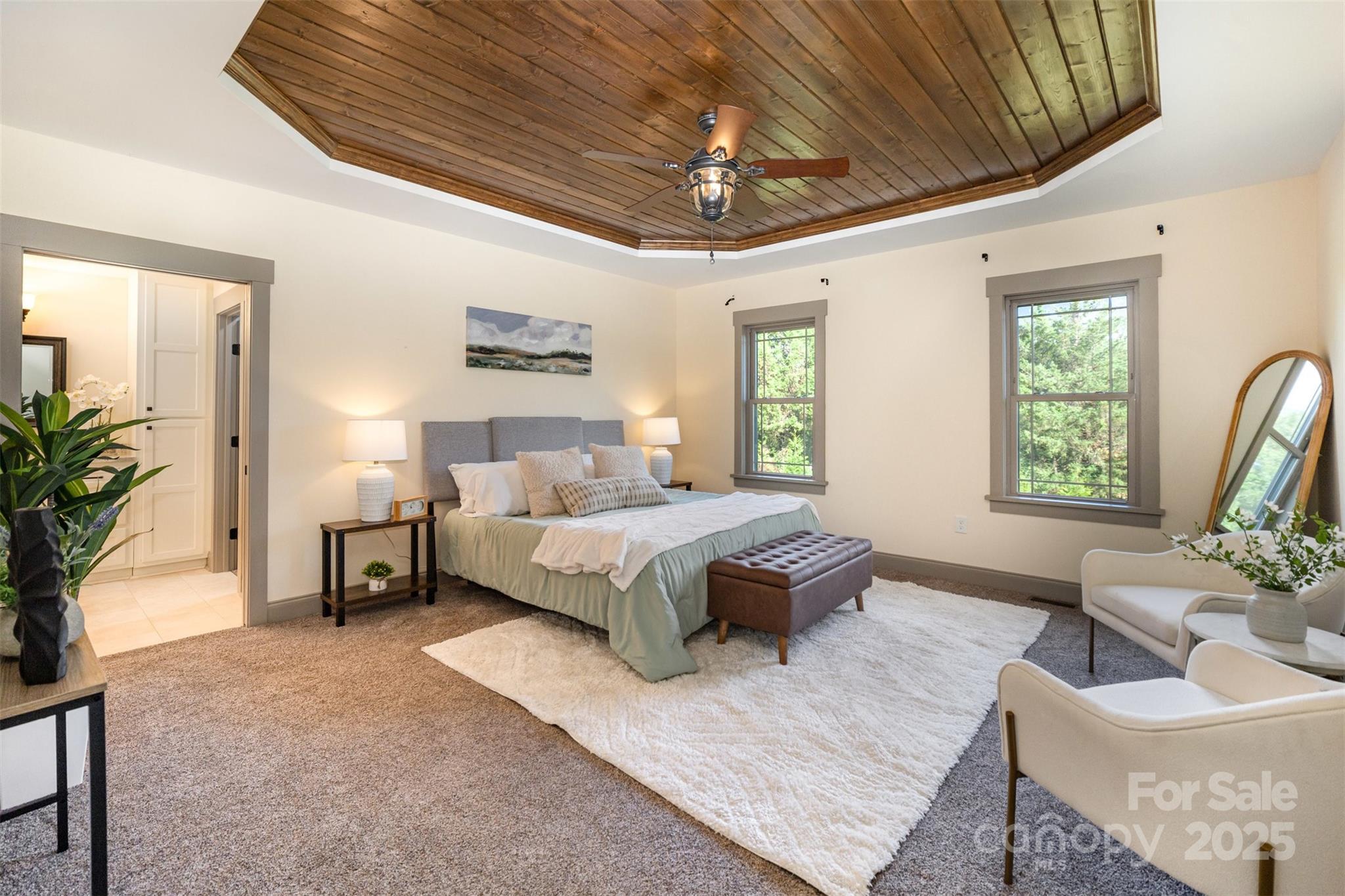 12041 Hazard Road Oakboro, NC 28129 - Photo 11 of 19 a spacious bedroom with a bed a couch and a potted plant