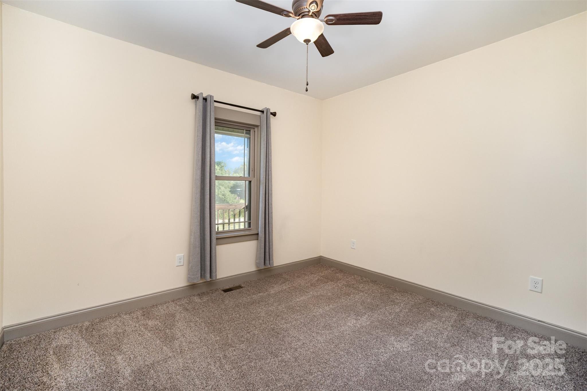 12041 Hazard Road Oakboro, NC 28129 - Photo 15 of 19 an empty room with a window and a fan
