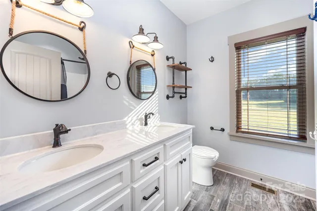 a bathroom with a toilet sink and mirror