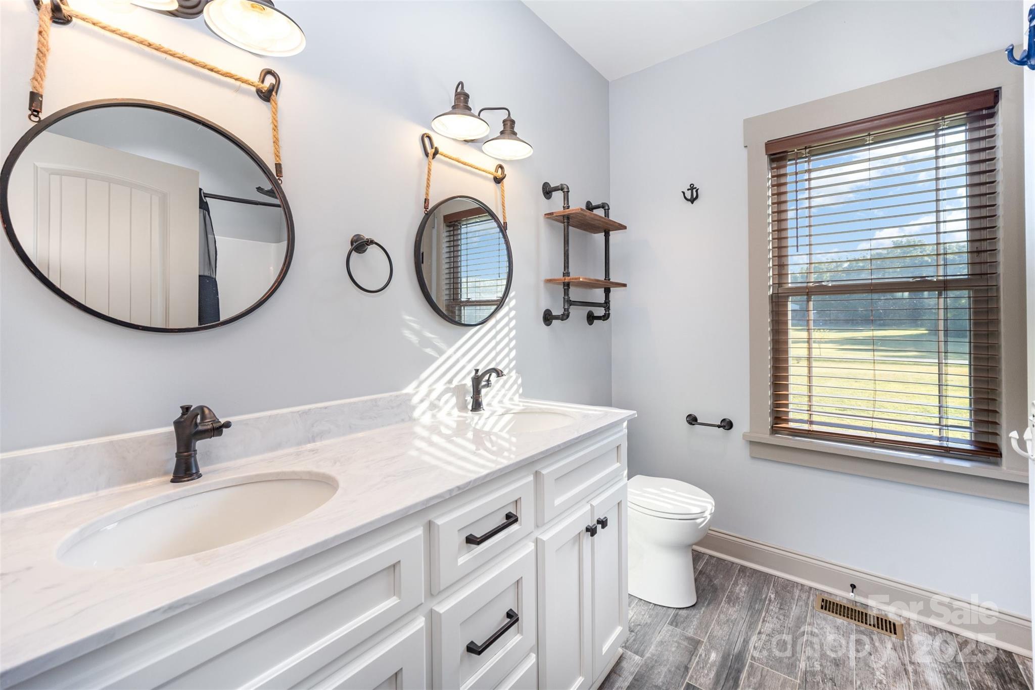 12041 Hazard Road Oakboro, NC 28129 - Photo 17 of 19 a bathroom with a toilet sink and mirror
