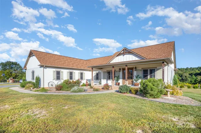 a front view of house with yard and green space