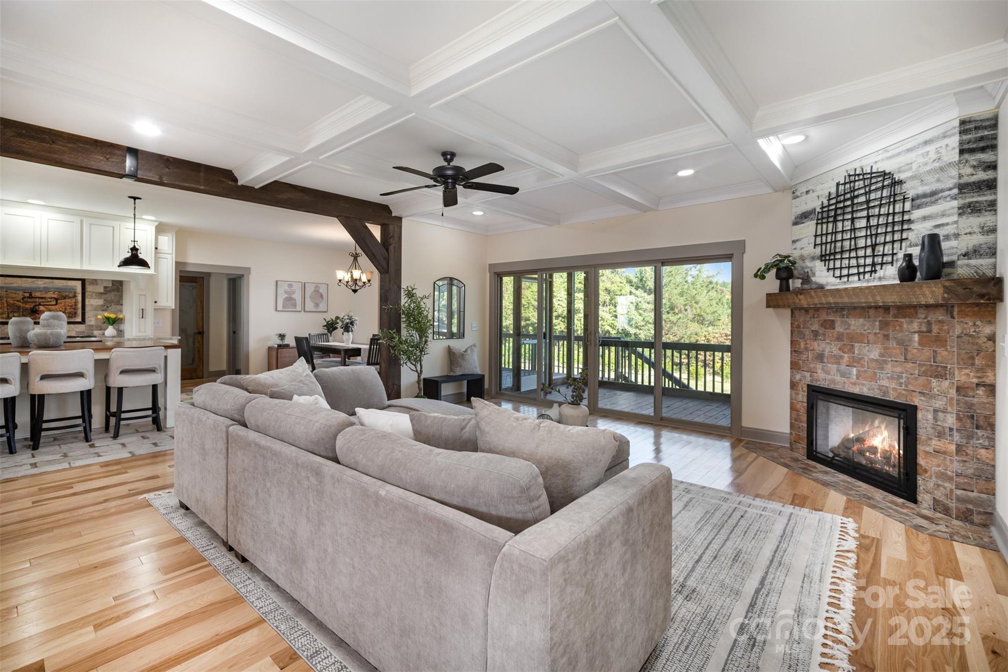 12041 Hazard Road Oakboro, NC 28129 - Photo 4 of 19 a living room with furniture a fireplace and a floor to ceiling window