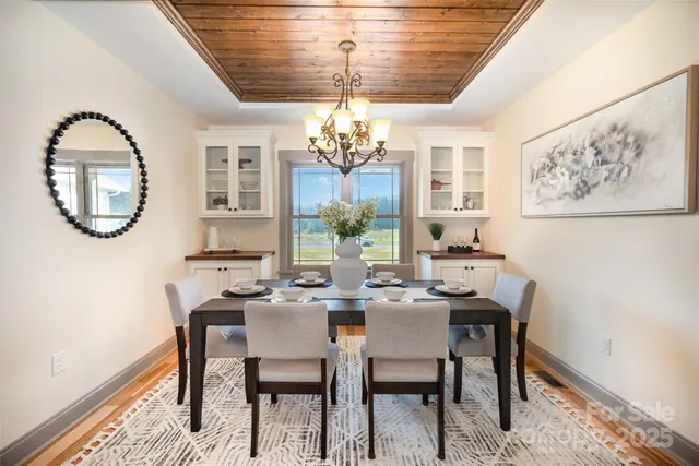 a view of a dining room with furniture and a chandelier