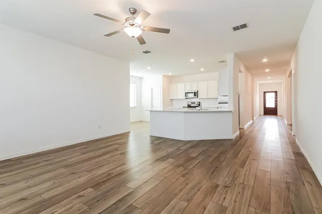 a view of a kitchen with wooden floor and a kitchen space