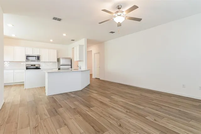 a view of kitchen with wooden floor and window