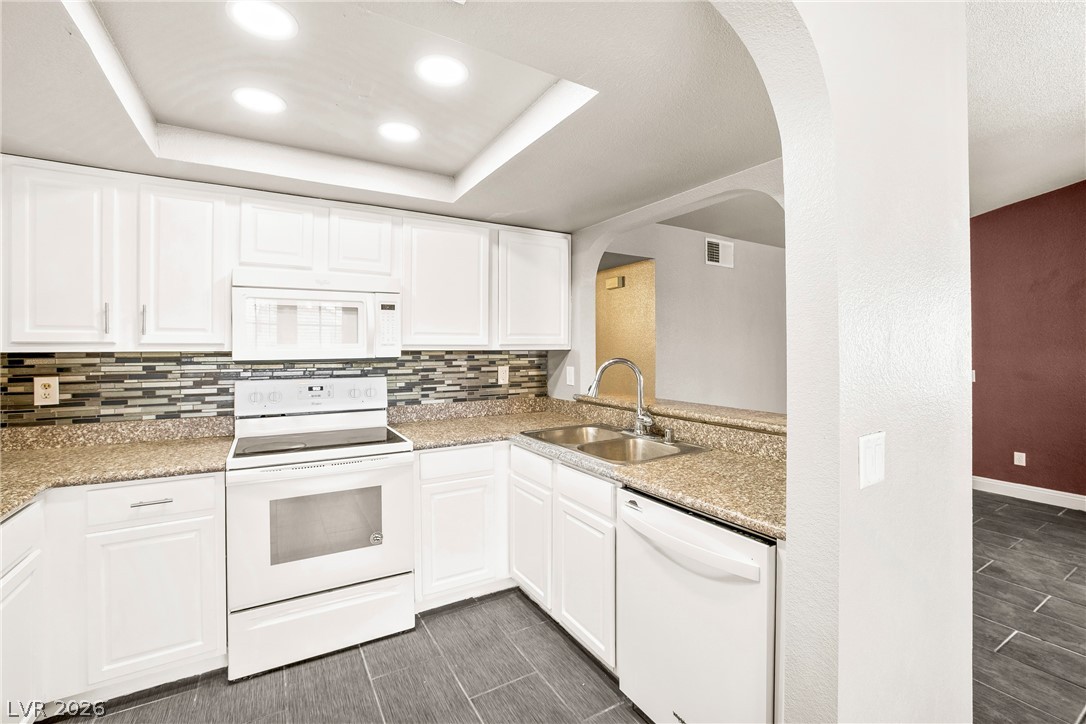 3311 Sunfish Drive, Unit D Henderson, NV 89014 - Photo 3 of 21 A well-appointed kitchen features ample cabinetry, durable countertops, and sleek tile flooring.