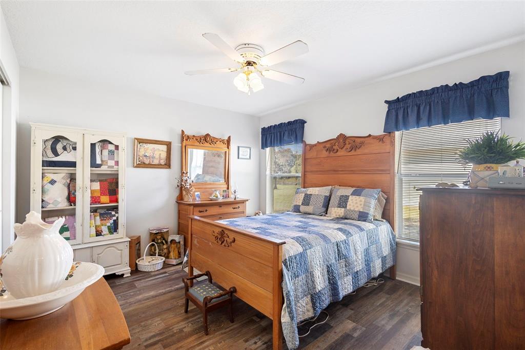 10320 Bumblebee Lane Leesburg, FL 34788 - Photo 21 of 49 a bedroom with a bed and wooden floor