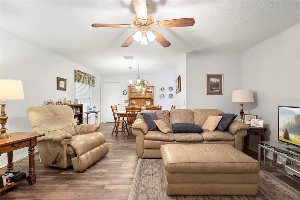 10320 Bumblebee Lane Leesburg, FL 34788 - Photo 29 of 49 a living room with furniture or chandelier and a wooden floor