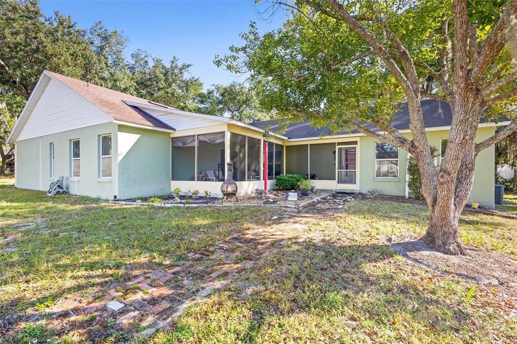 10320 Bumblebee Lane Leesburg, FL 34788 - Photo 40 of 49 a view of a house with backyard and sitting area