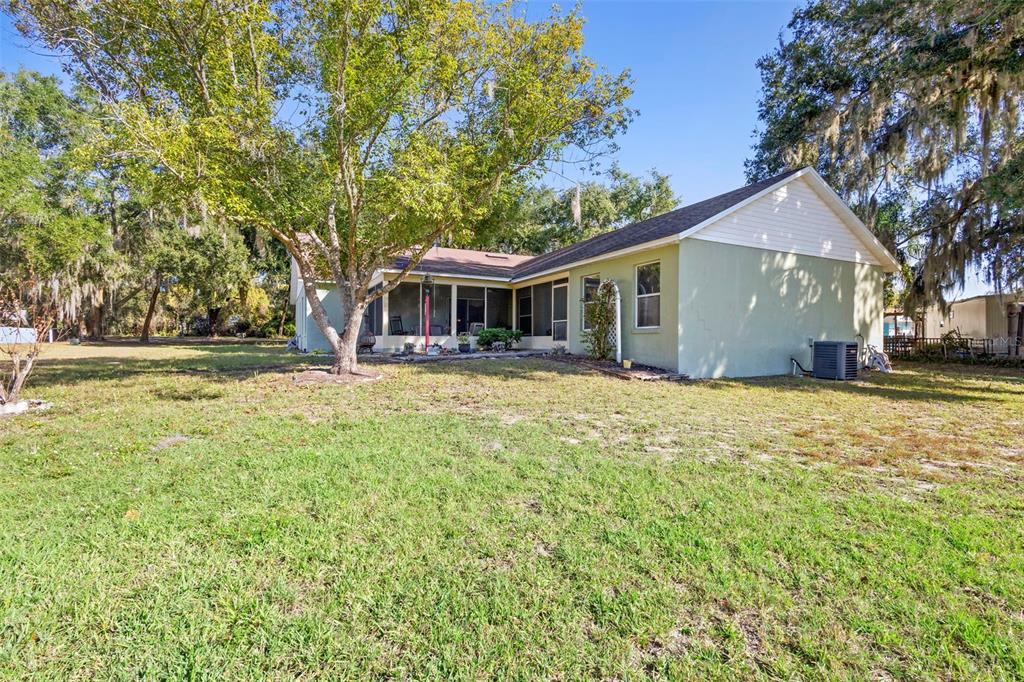 10320 Bumblebee Lane Leesburg, FL 34788 - Photo 43 of 49 a front view of a house with a yard and trees