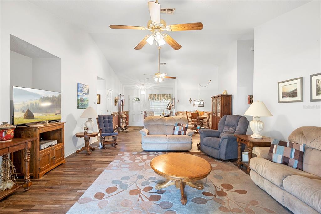 10320 Bumblebee Lane Leesburg, FL 34788 - Photo 6 of 49 a living room filled with furniture and a flat screen tv