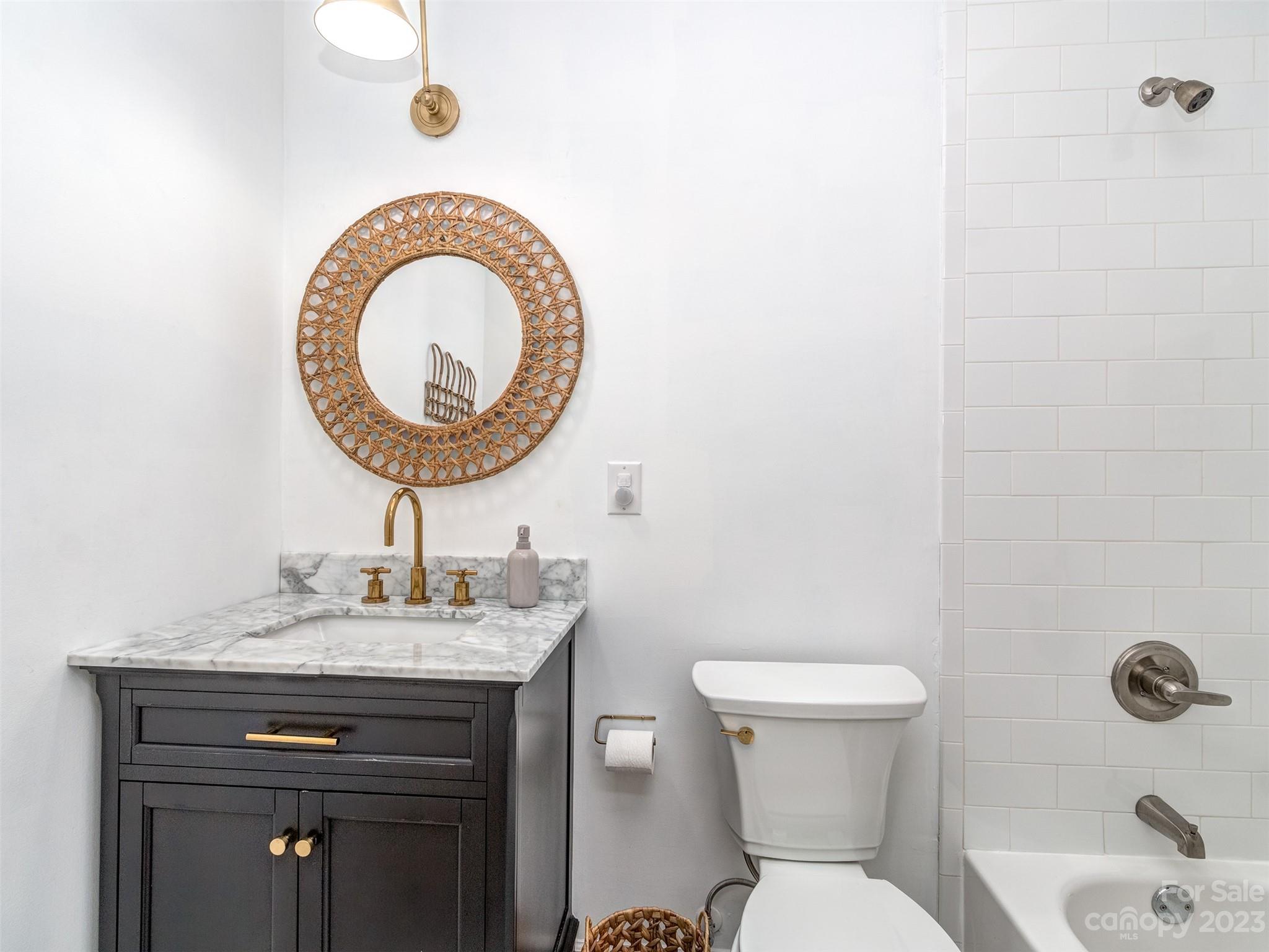 2819 Eastburn Road Charlotte, NC 28210 - Photo 13 of 34 a bathroom with a sink a toilet and a mirror