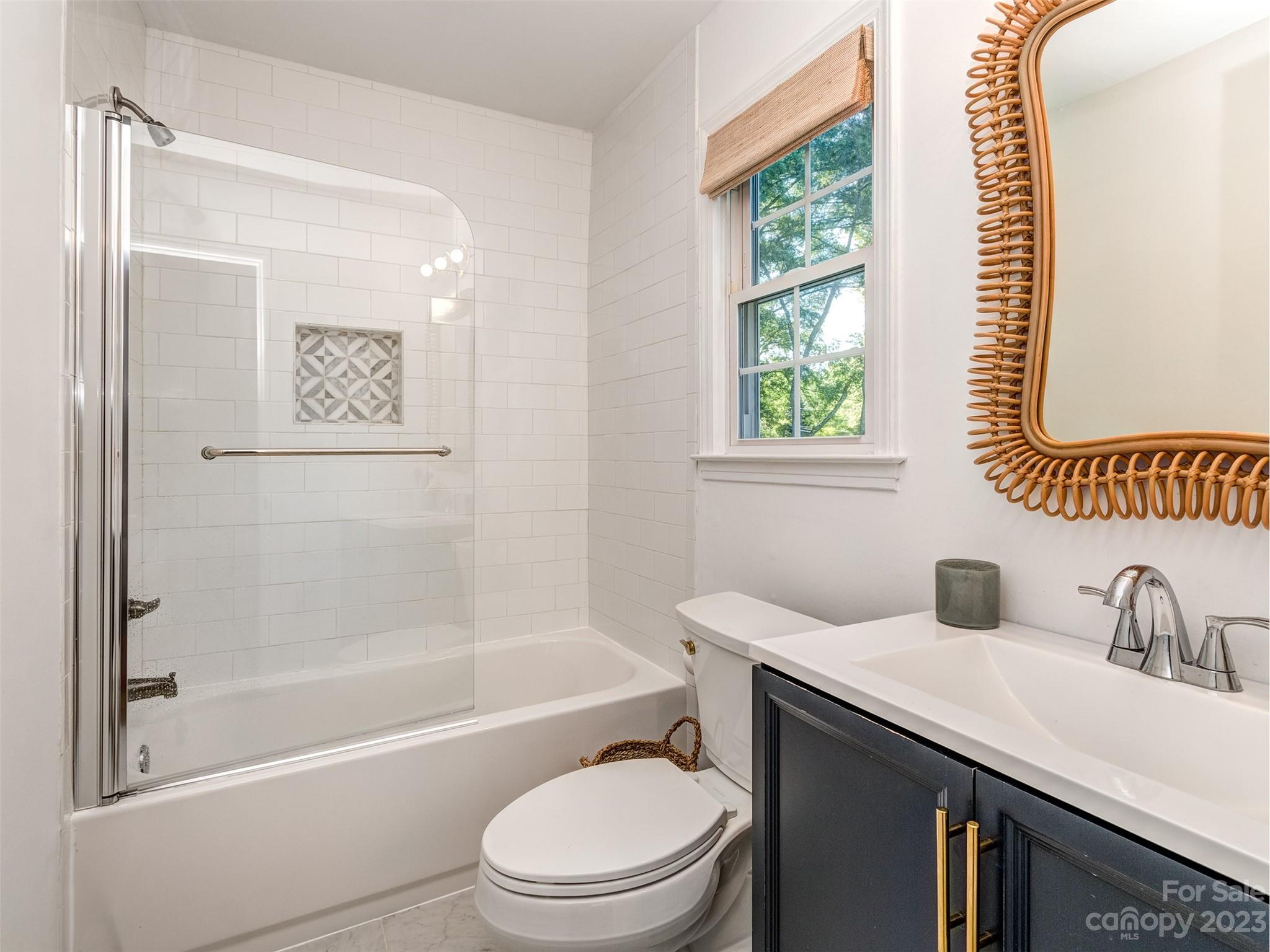 2819 Eastburn Road Charlotte, NC 28210 - Photo 16 of 34 a bathroom with a sink a toilet and shower