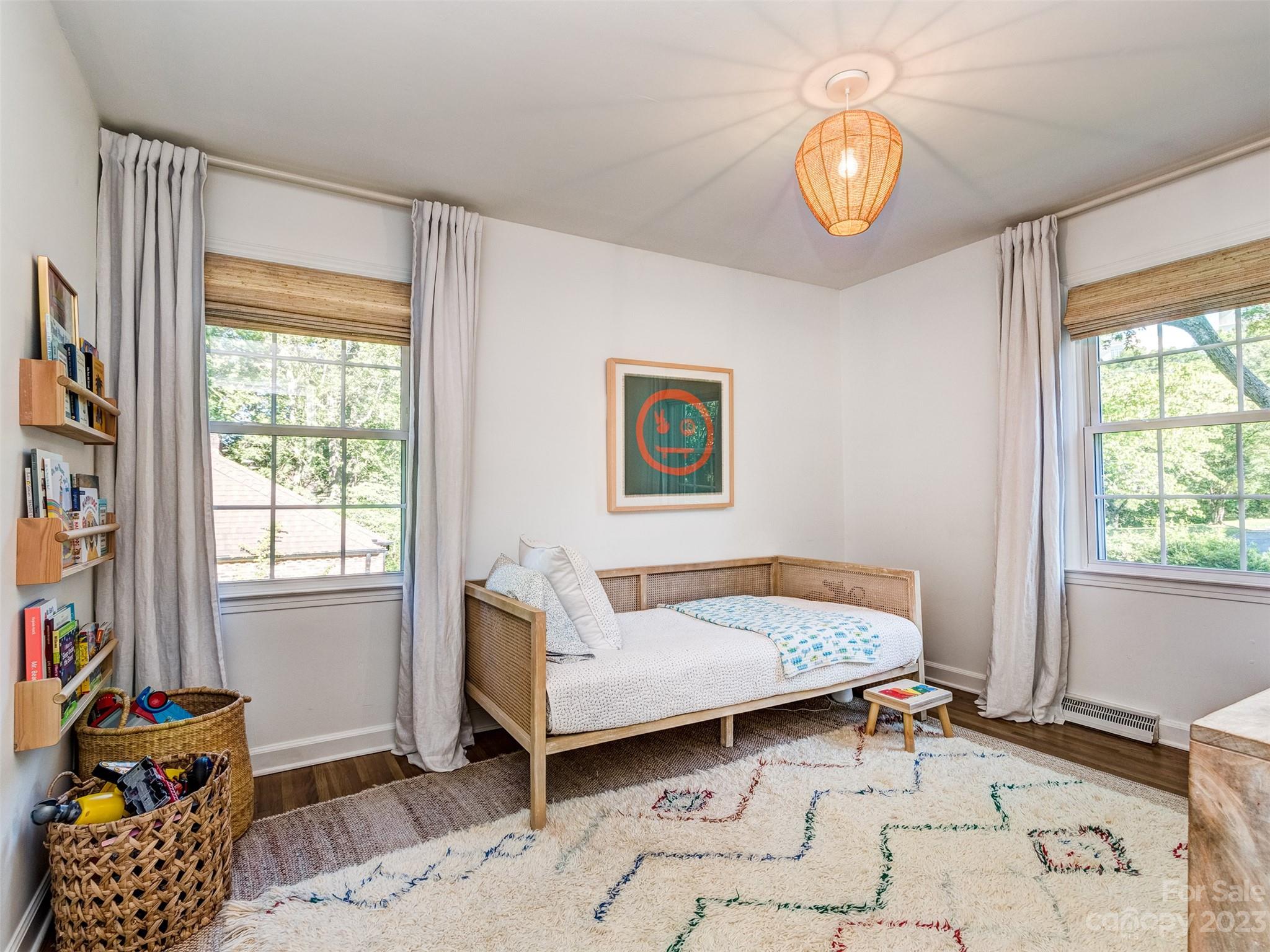 2819 Eastburn Road Charlotte, NC 28210 - Photo 17 of 34 a bedroom with a bed and a chandelier