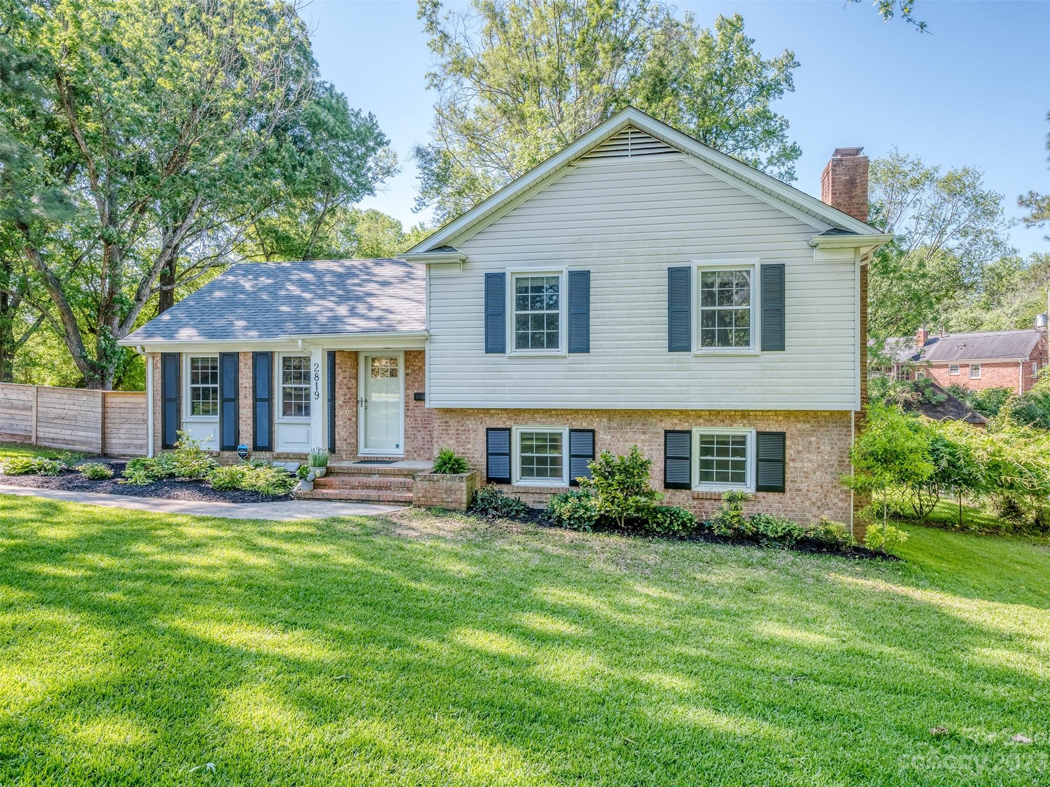 2819 Eastburn Road Charlotte, NC 28210 - Photo 2 of 34 a front view of a house with a yard and garage