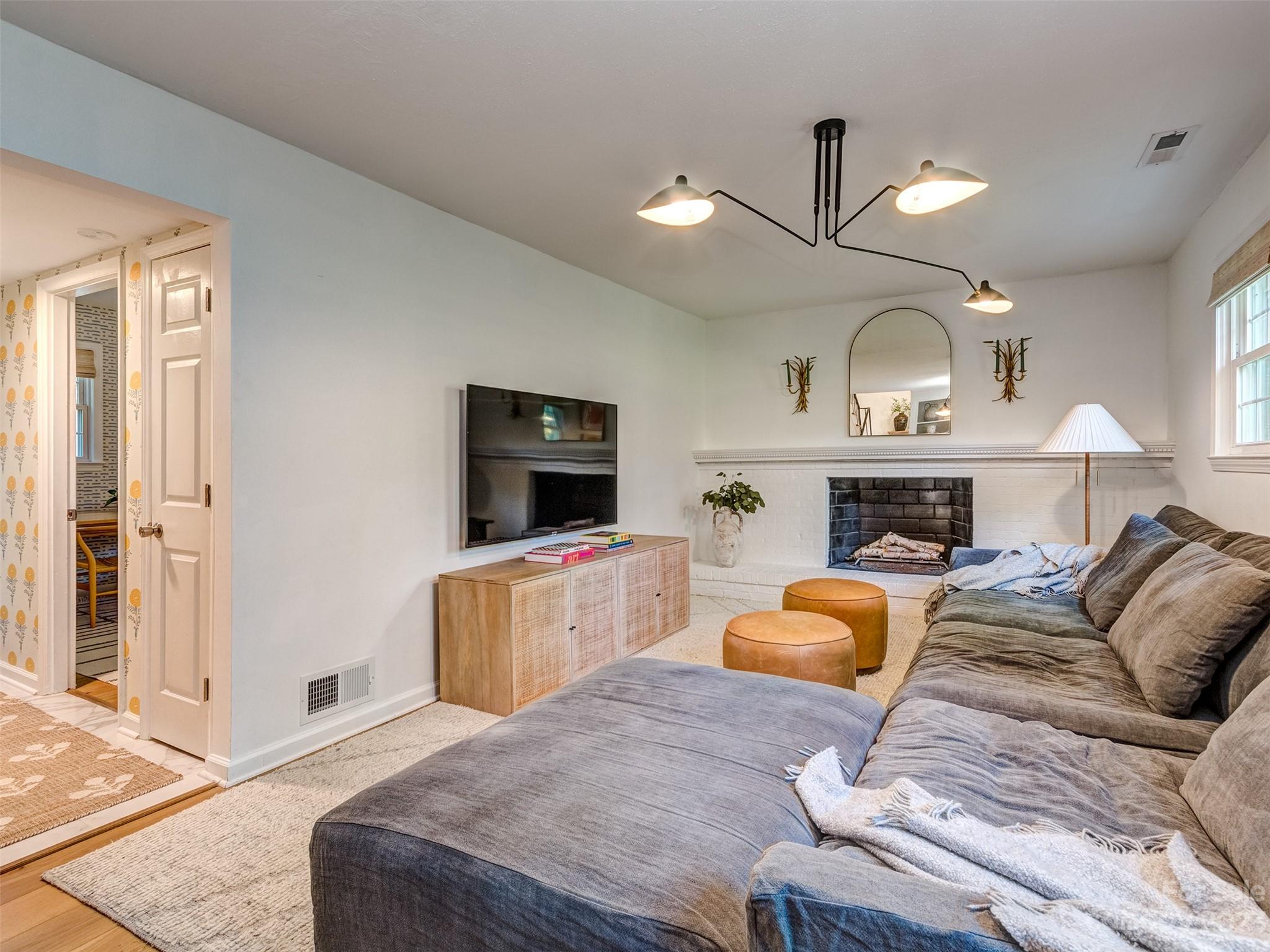 2819 Eastburn Road Charlotte, NC 28210 - Photo 21 of 34 a living room with furniture a fireplace and a flat screen tv