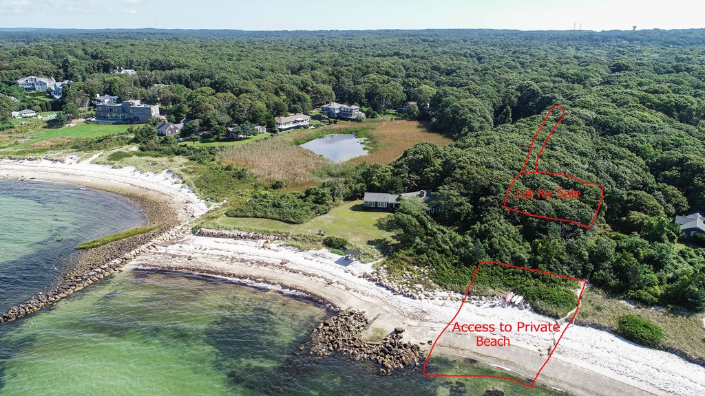 a view of a lake with beach and city view