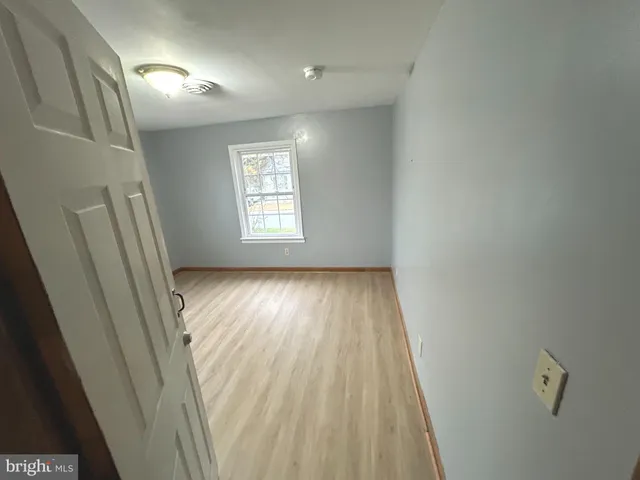 a view of room with window and hardwood floor