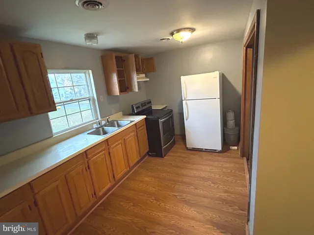 a kitchen with a refrigerator and a stove