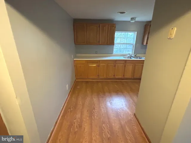 a room with wooden floor and window