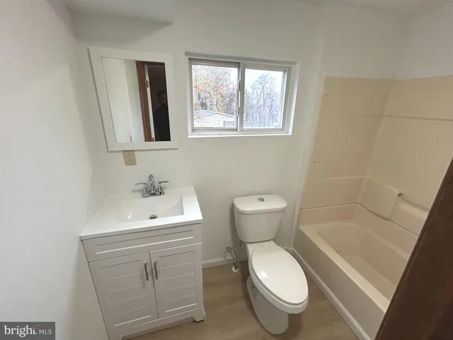 a bathroom with a sink toilet and a mirror