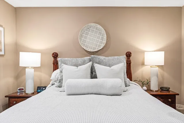 a bedroom with a bed and a lamp