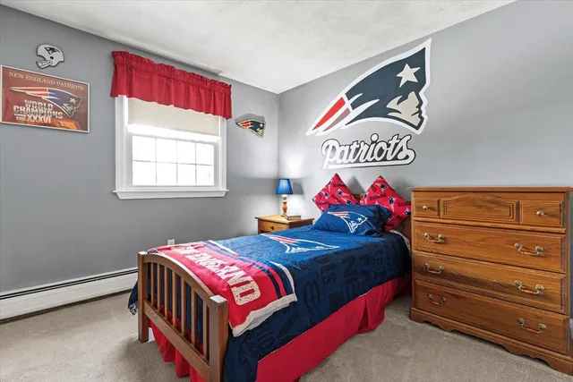 a bedroom with a bed and a dresser in it