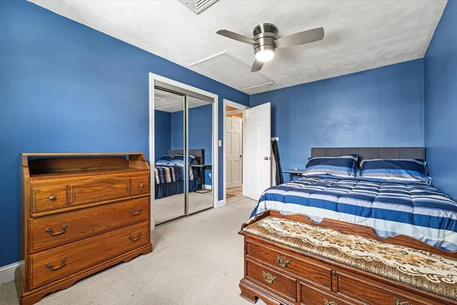 a bedroom with a bed and a dresser