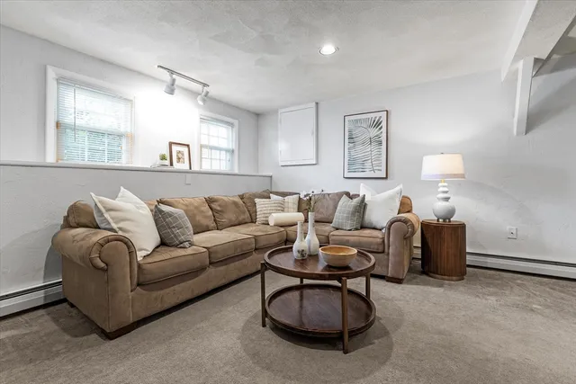 a living room with furniture a large window and a lamp