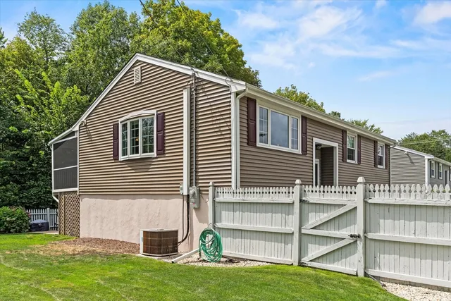 a view of house with a yard