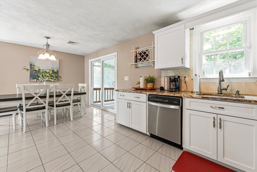 42 Crescent Saugus Ma Saugus, MA 01906 - Photo 4 of 38 a kitchen with a sink and chairs
