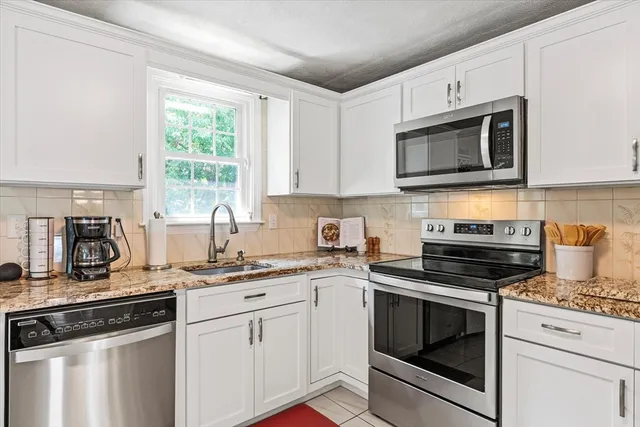 a kitchen with cabinets stainless steel appliances a sink and a counter space